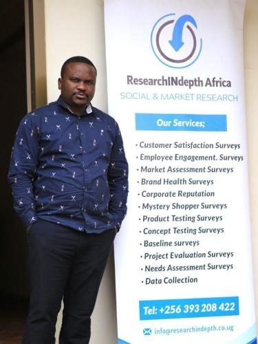 Team member beside the RIA service banner